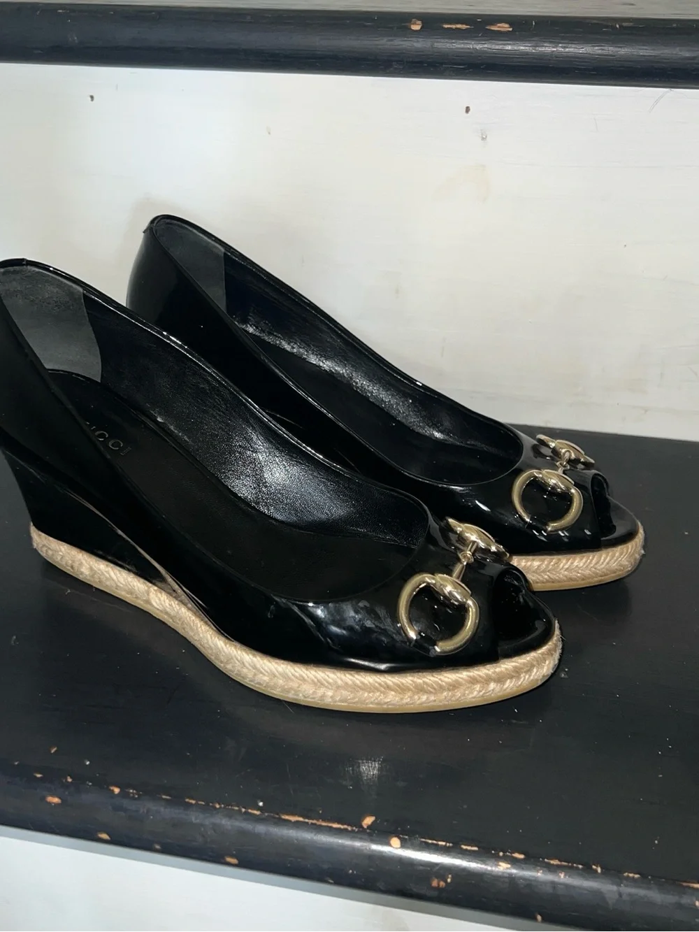 Black patent leather Gucci wedges with horsebit and peep toe